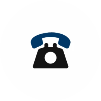 The hand of a person holding a scanner and pointing it at the barcode on the end of an archive box on a shelf