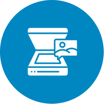 The hand of a person holding a scanner and pointing it at the barcode on the end of an archive box on a shelf